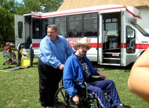 Photo of Pastor David pushing a man in a wheelchair