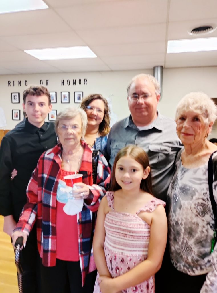 The gibson family stands for a photo in the fellowship hall