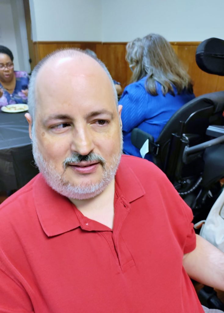 Pastor Larry in a red, collared shirt